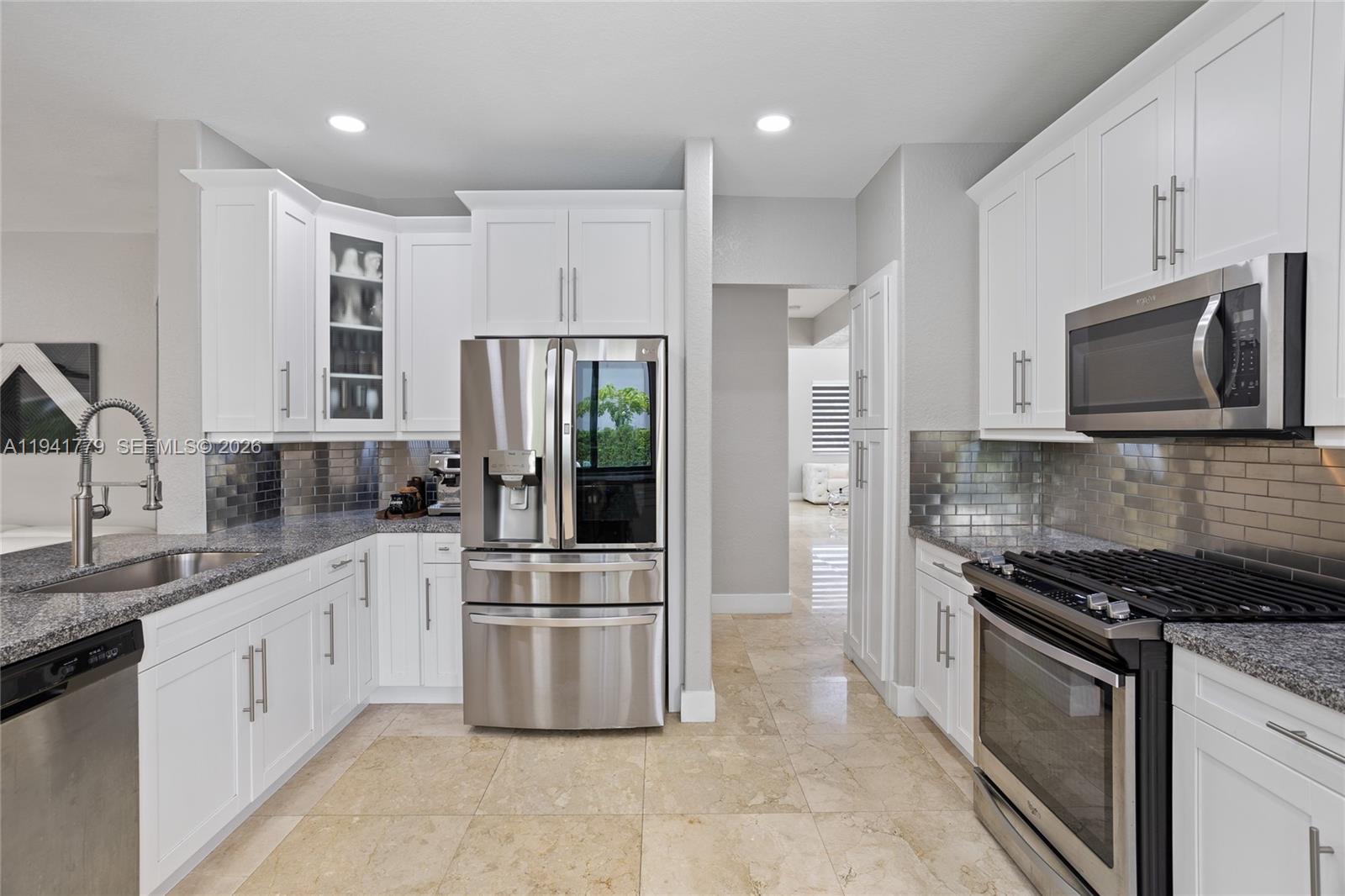 5324 Southwest 164th Court Miami, FL 33185 - Photo 26 of 47 a kitchen with white cabinets and appliances