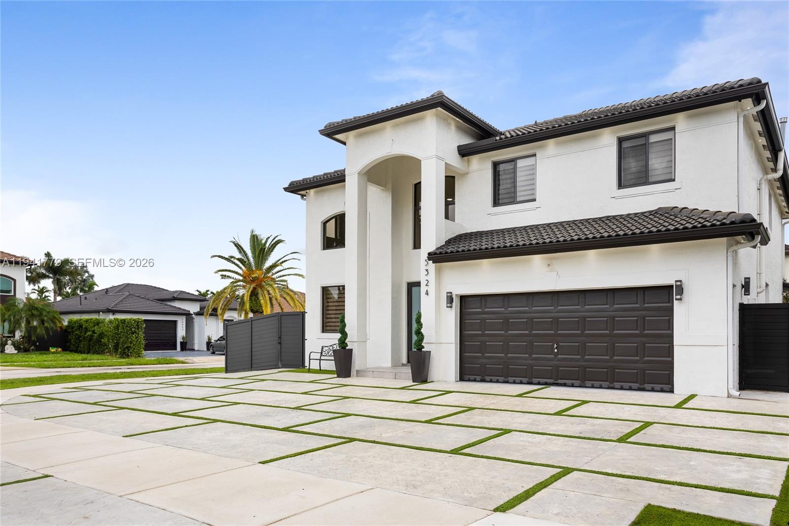 5324 Southwest 164th Court Miami, FL 33185 - Photo 3 of 47 a front view of a house with a yard and garage