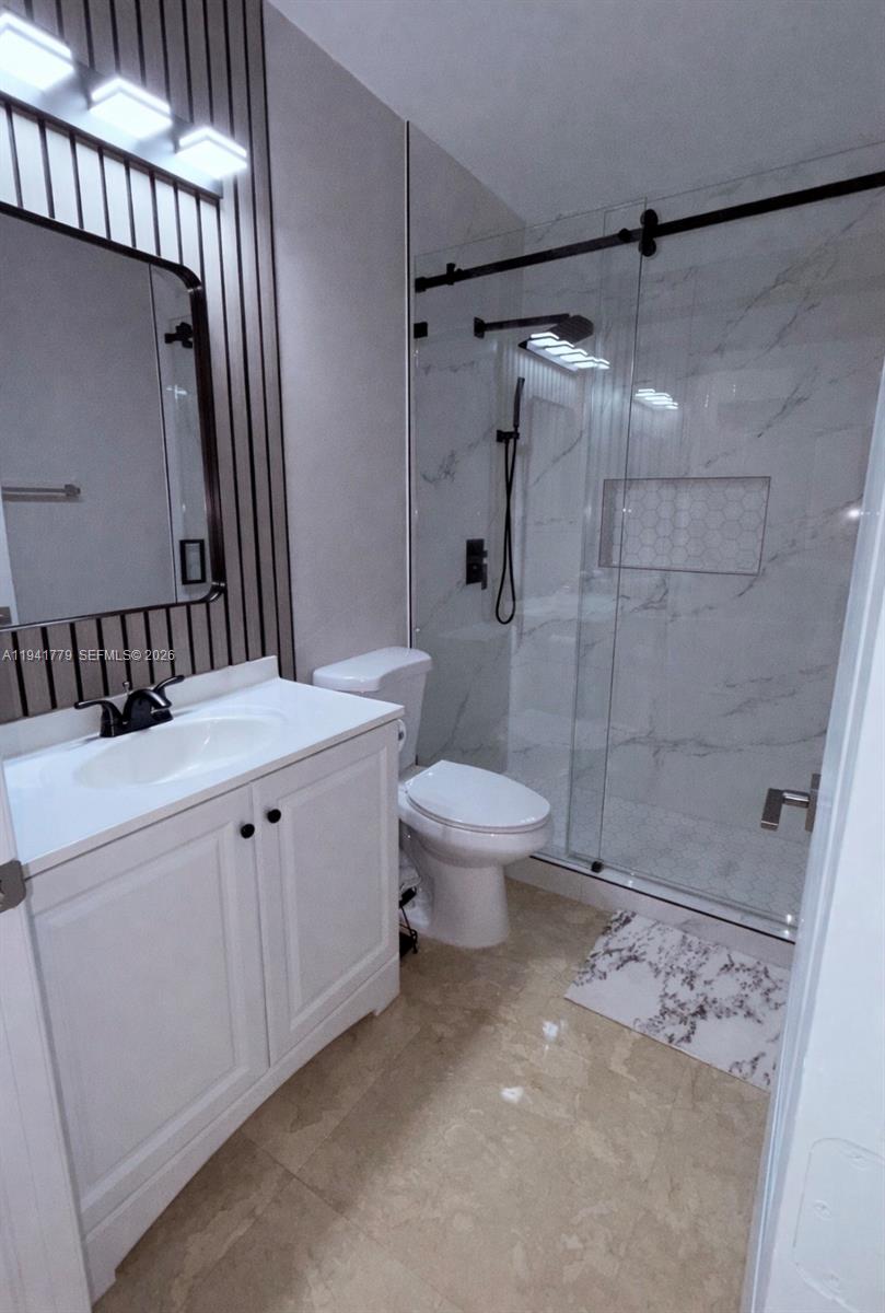 5324 Southwest 164th Court Miami, FL 33185 - Photo 31 of 47 a bathroom with a sink a toilet and shower