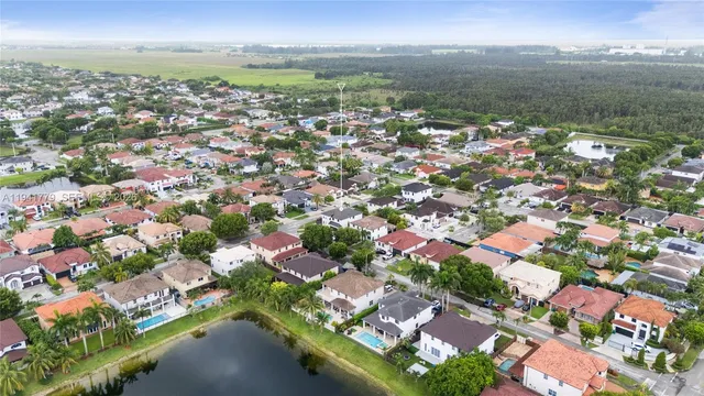 an aerial view of residential houses with outdoor space and river
