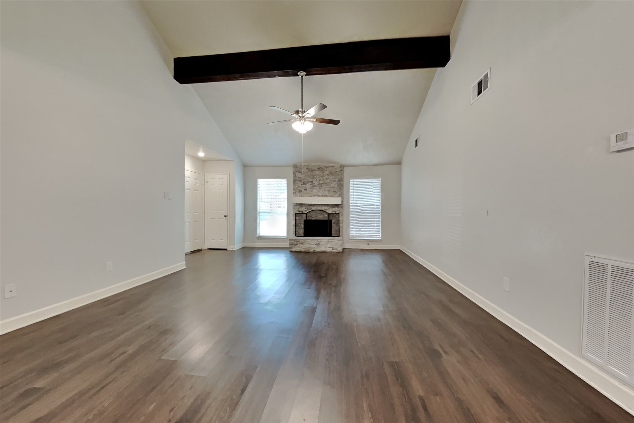 40 Rockfern Road Spring, TX 77380 - Photo 2 of 19 an empty room with wooden floor fireplace and windows