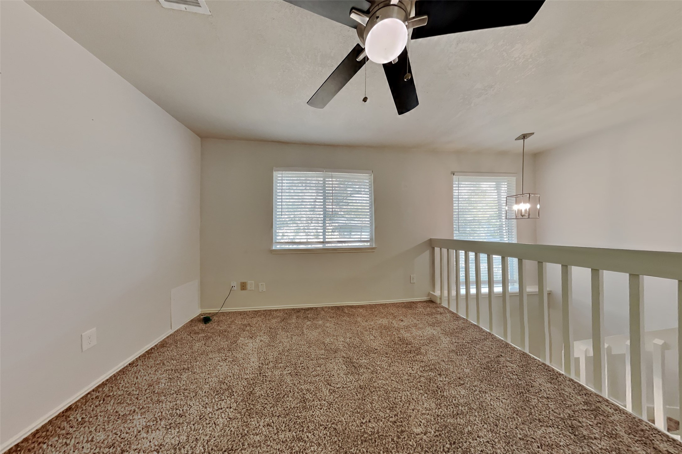40 Rockfern Road Spring, TX 77380 - Photo 5 of 19 an empty room with chandelier fan and windows