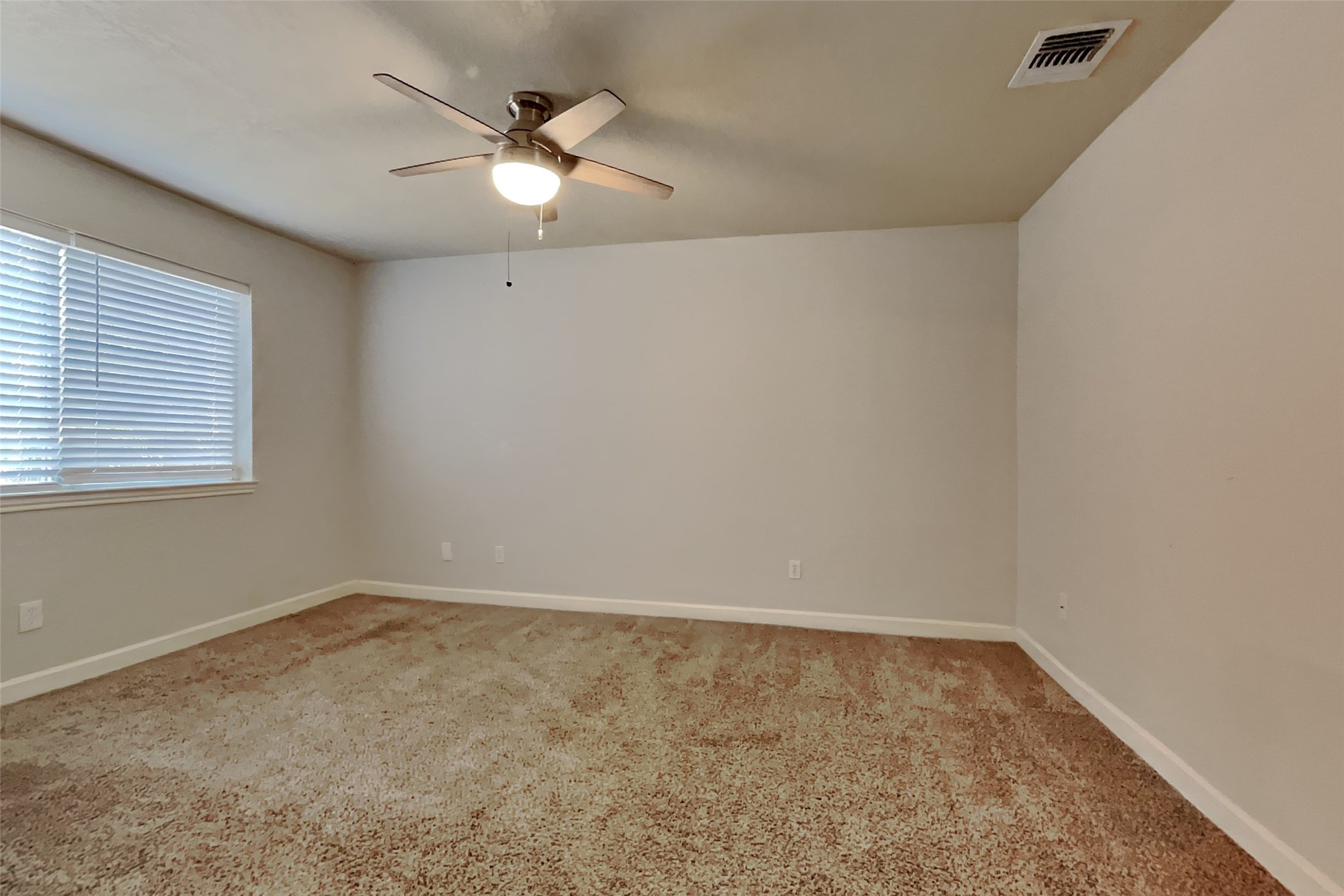 40 Rockfern Road Spring, TX 77380 - Photo 10 of 19 an empty room with a ceiling fan and window