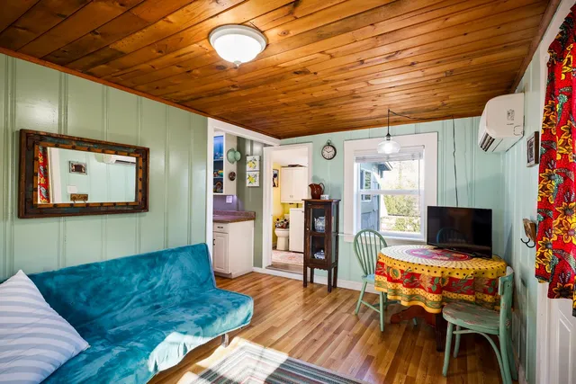 a living room with furniture rug and wooden floor