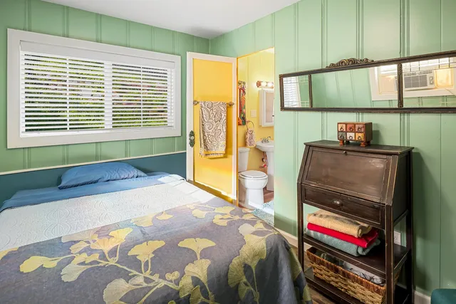 a bedroom with a bed and a television