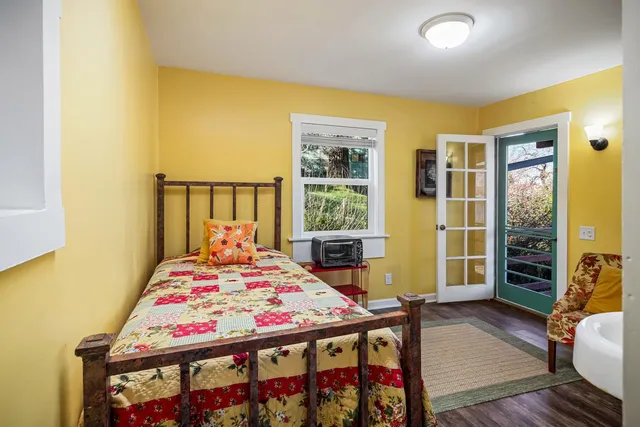 a bedroom that has a bed and a table in it