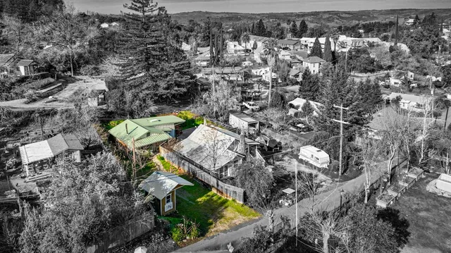 an aerial view of residential houses with outdoor space