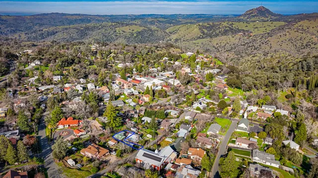 an aerial view of a house with swimming pool and garden