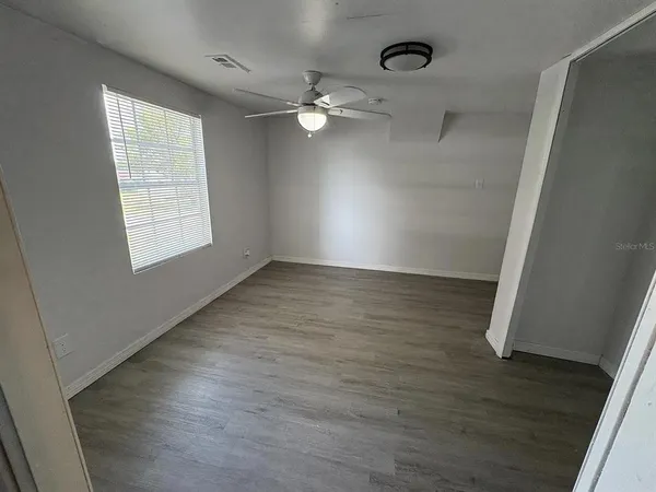 wooden floor in an empty room with a window