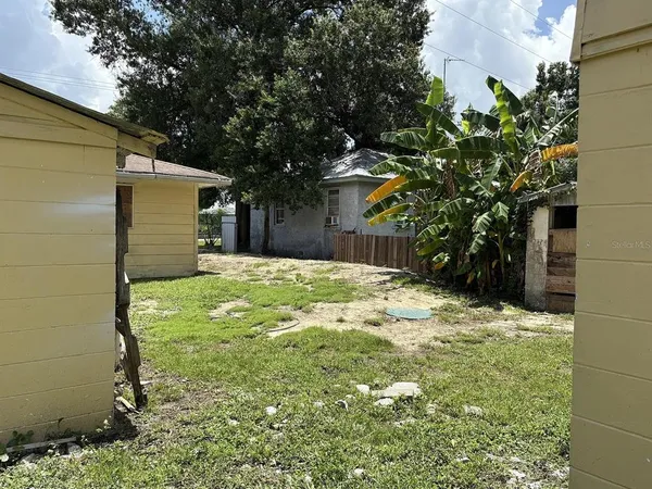 a backyard of a house with large trees