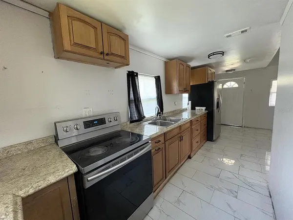 a kitchen with stainless steel appliances granite countertop a sink and a stove