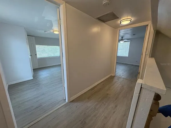 a view of hallway with wooden floor
