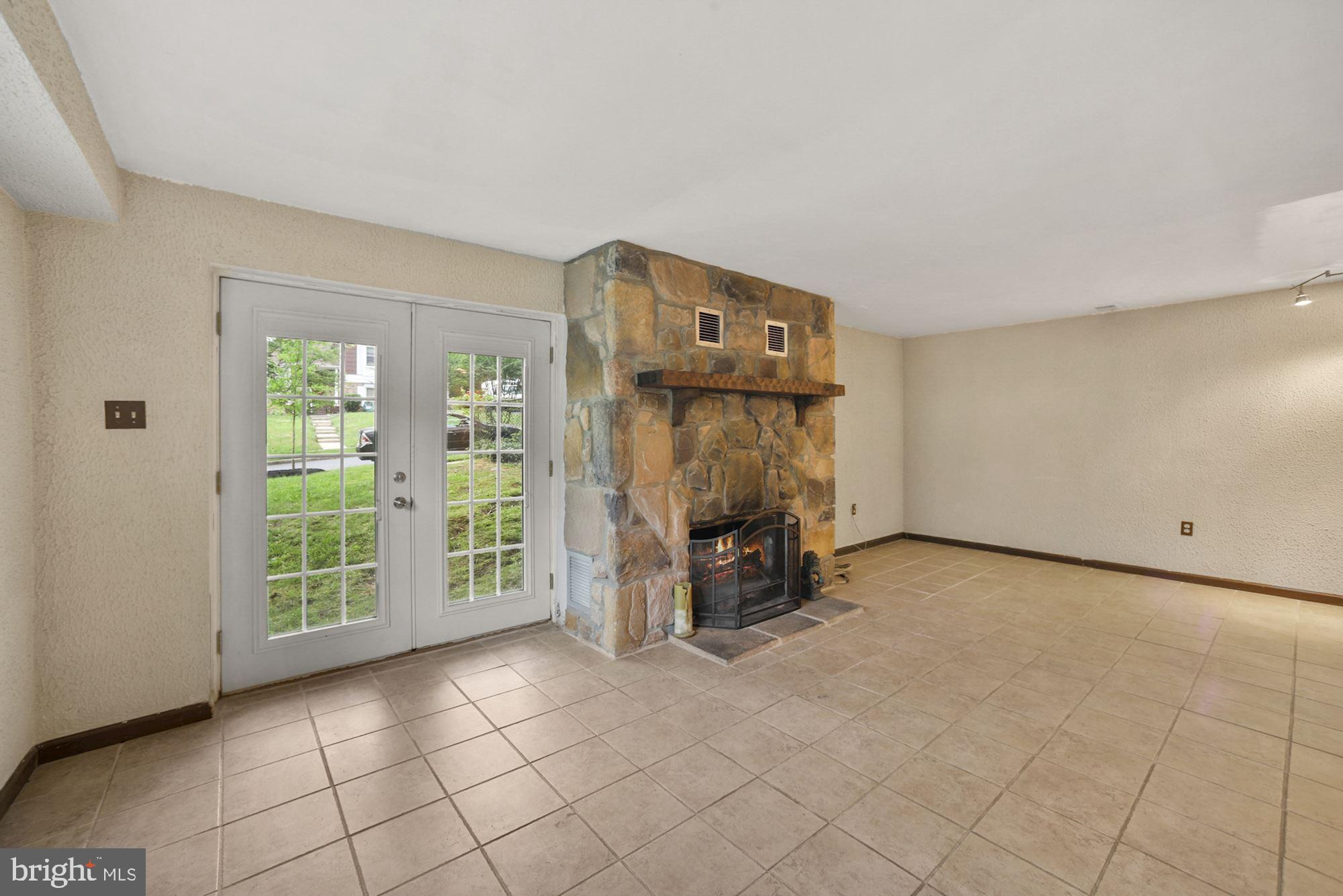 8429 Oak Stream Drive Laurel, MD 20708 - Photo 23 of 37 Large lower level rec room with fireplace