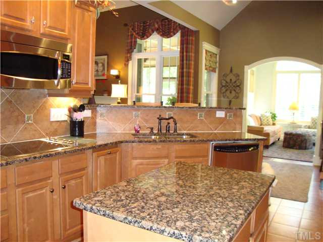 7316 Duncans Ridge Way Fuquay-Varina, NC 27526 - Photo 8 of 25 Designer Kitchen with the works. This view gives a feel for Sunroom just off Kitchen, Living Room and Screened in Porch.