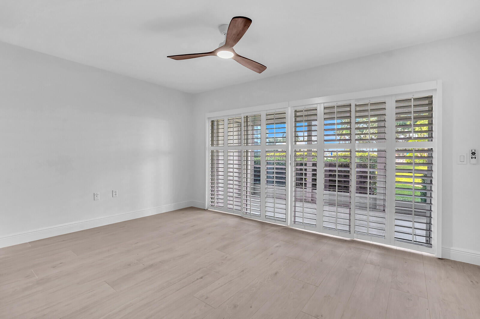 145 Atlantis Boulevard, Unit 104 Atlantis, FL 33462 - Photo 13 of 49 a view of a livingroom with wooden floor and a window