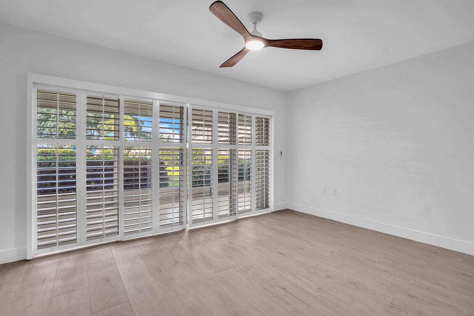 145 Atlantis Boulevard, Unit 104 Atlantis, FL 33462 - Photo 14 of 49 a view of a room with sliding glass door