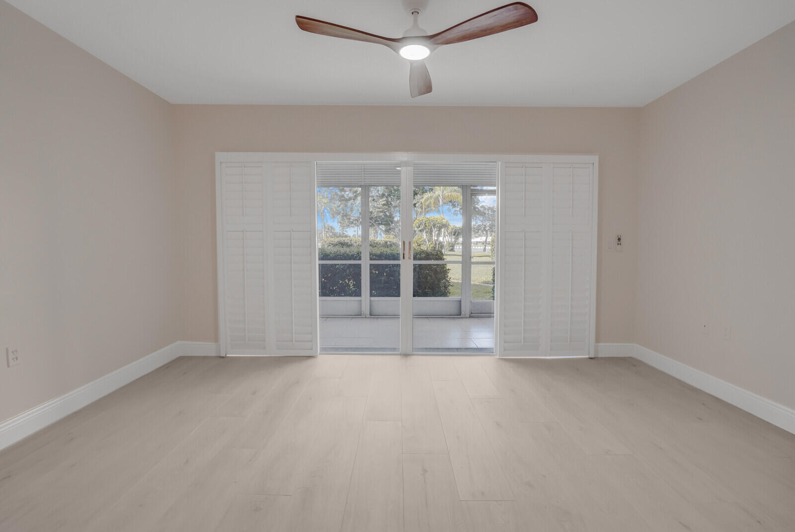 145 Atlantis Boulevard, Unit 104 Atlantis, FL 33462 - Photo 16 of 49 a view of empty room with wooden floor