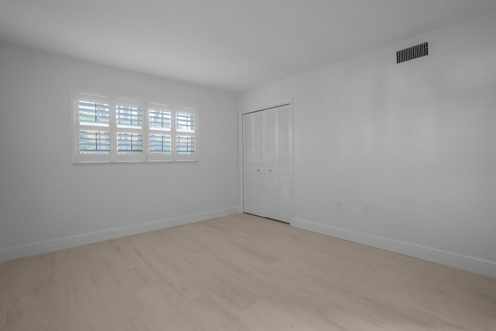 145 Atlantis Boulevard, Unit 104 Atlantis, FL 33462 - Photo 25 of 49 an empty room with a window