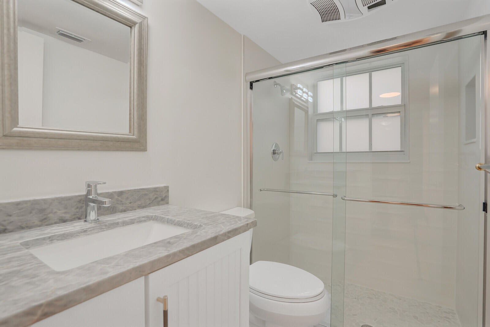 145 Atlantis Boulevard, Unit 104 Atlantis, FL 33462 - Photo 26 of 49 a bathroom with a granite countertop sink toilet and shower