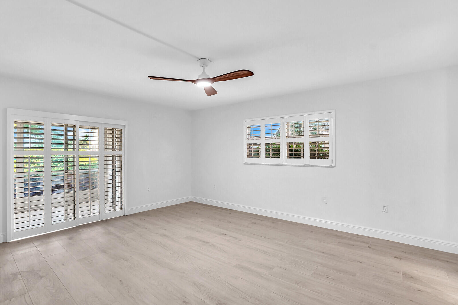 145 Atlantis Boulevard, Unit 104 Atlantis, FL 33462 - Photo 28 of 49 a view of an empty room with glass door