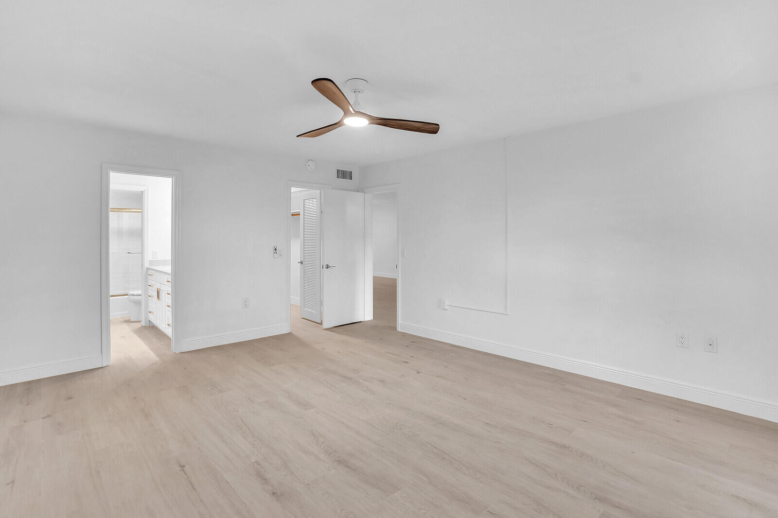 145 Atlantis Boulevard, Unit 104 Atlantis, FL 33462 - Photo 30 of 49 an empty room with a empty space and a ceiling fan