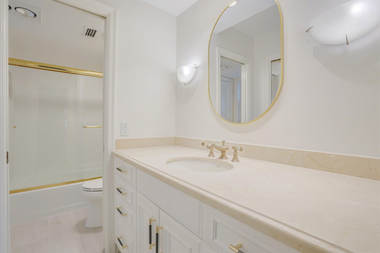 145 Atlantis Boulevard, Unit 104 Atlantis, FL 33462 - Photo 31 of 49 a bathroom with a sink a toilet and a mirror