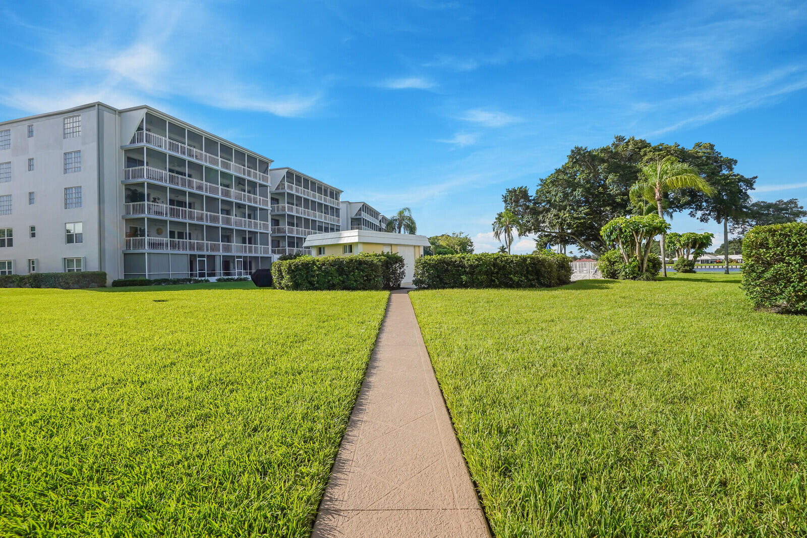145 Atlantis Boulevard, Unit 104 Atlantis, FL 33462 - Photo 39 of 49 a view of building with garden