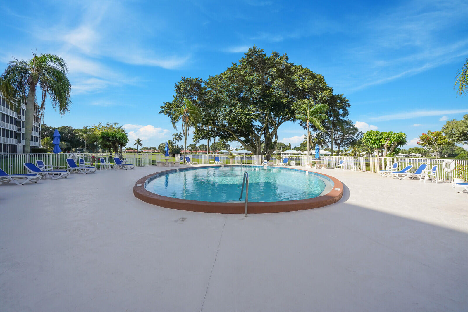 145 Atlantis Boulevard, Unit 104 Atlantis, FL 33462 - Photo 42 of 49 a view of a swimming pool with an outdoor space and seating area