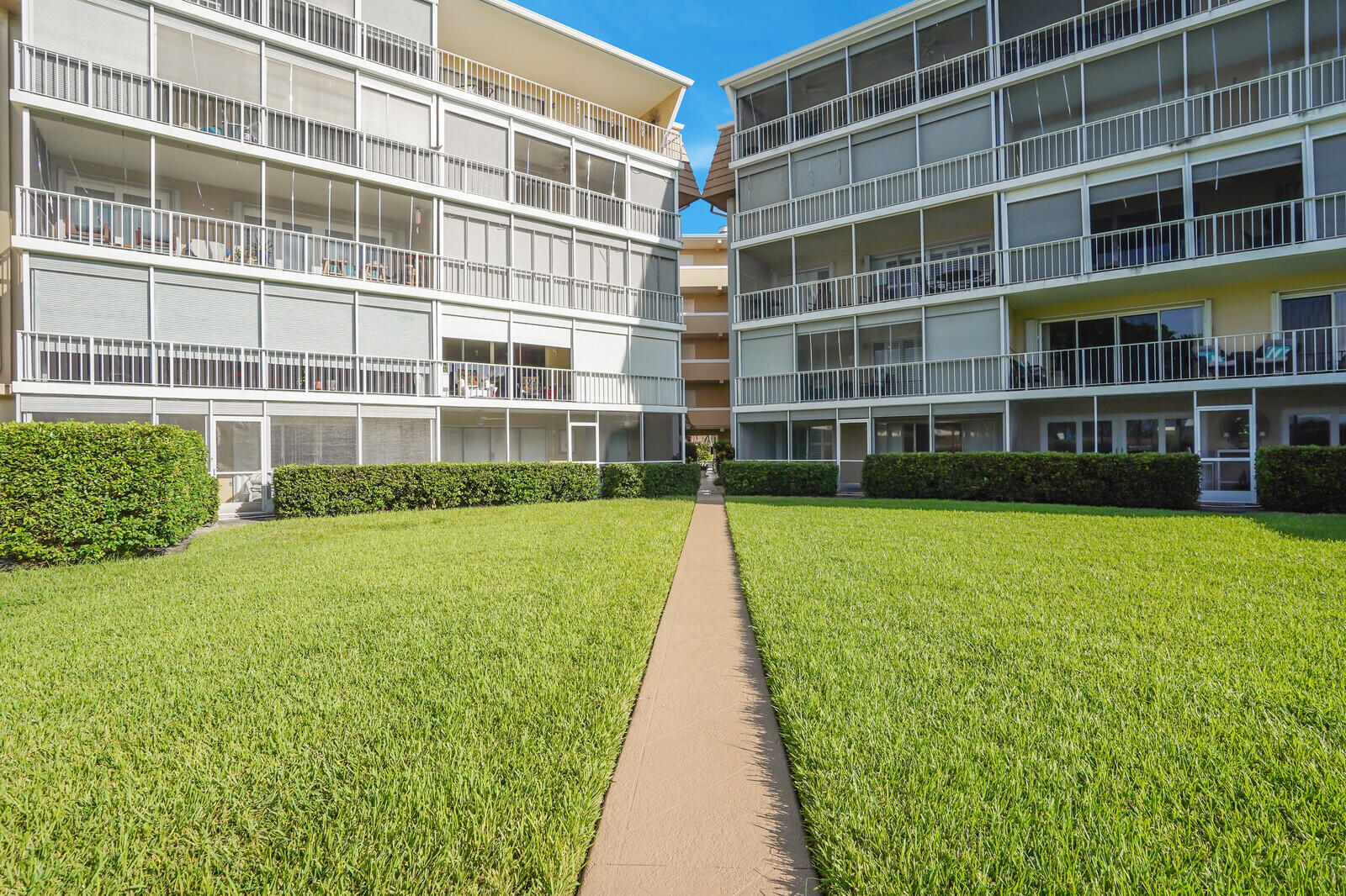145 Atlantis Boulevard, Unit 104 Atlantis, FL 33462 - Photo 46 of 49 a view of a building with a big yard