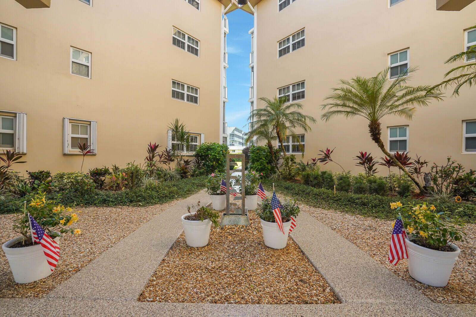 145 Atlantis Boulevard, Unit 104 Atlantis, FL 33462 - Photo 47 of 49 a view of a terrace with sitting area