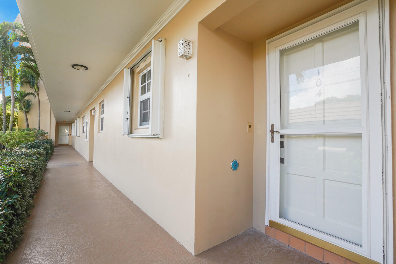 145 Atlantis Boulevard, Unit 104 Atlantis, FL 33462 - Photo 48 of 49 a view of a hallway with wooden floor and windows