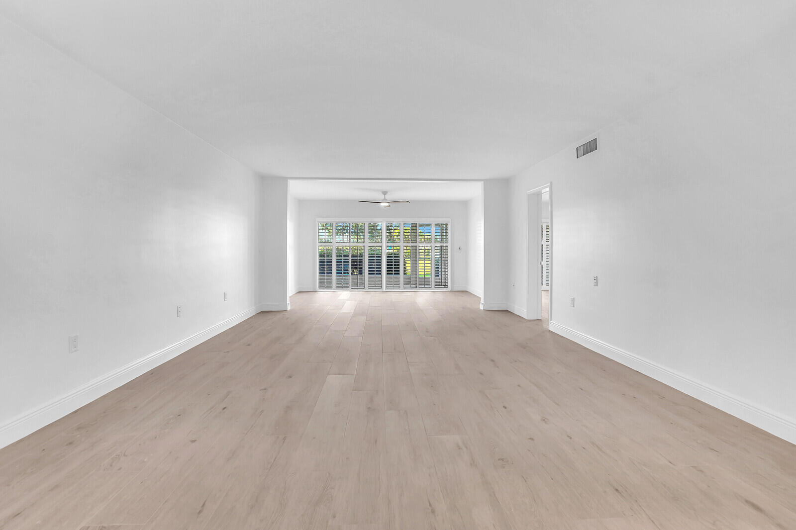 145 Atlantis Boulevard, Unit 104 Atlantis, FL 33462 - Photo 5 of 49 an empty room with windows