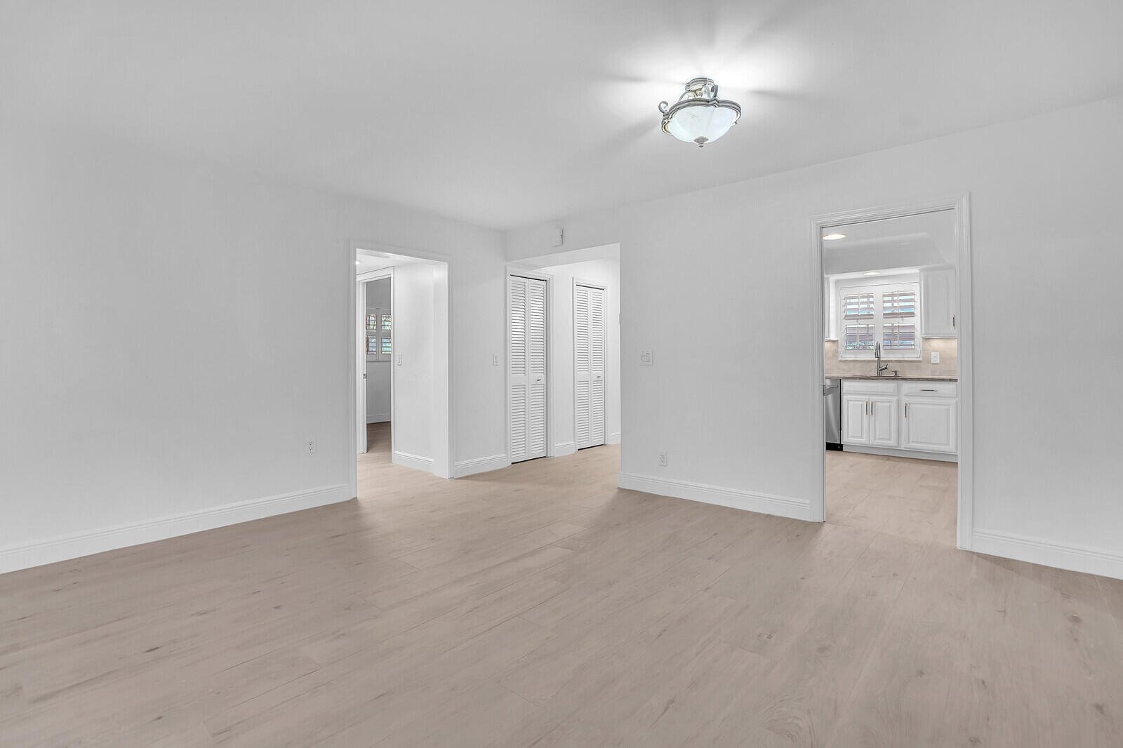 145 Atlantis Boulevard, Unit 104 Atlantis, FL 33462 - Photo 7 of 49 a view of an empty room with a window
