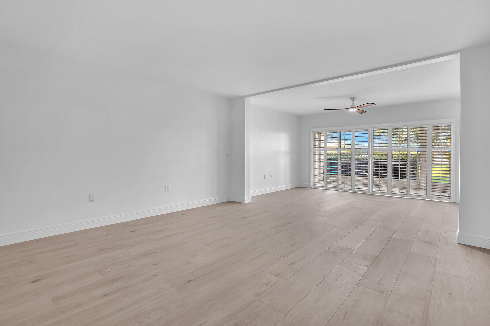 145 Atlantis Boulevard, Unit 104 Atlantis, FL 33462 - Photo 9 of 49 a view of an empty room with a window