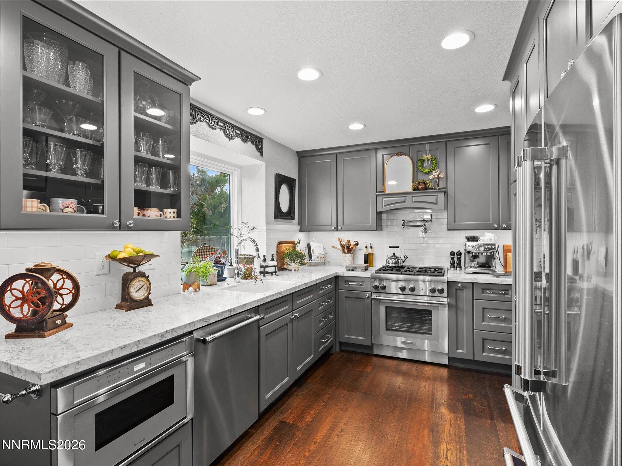 1164 Mayflower Drive Reno, NV 89509 - Photo 13 of 89 a kitchen with stainless steel appliances granite countertop a stove and a sink