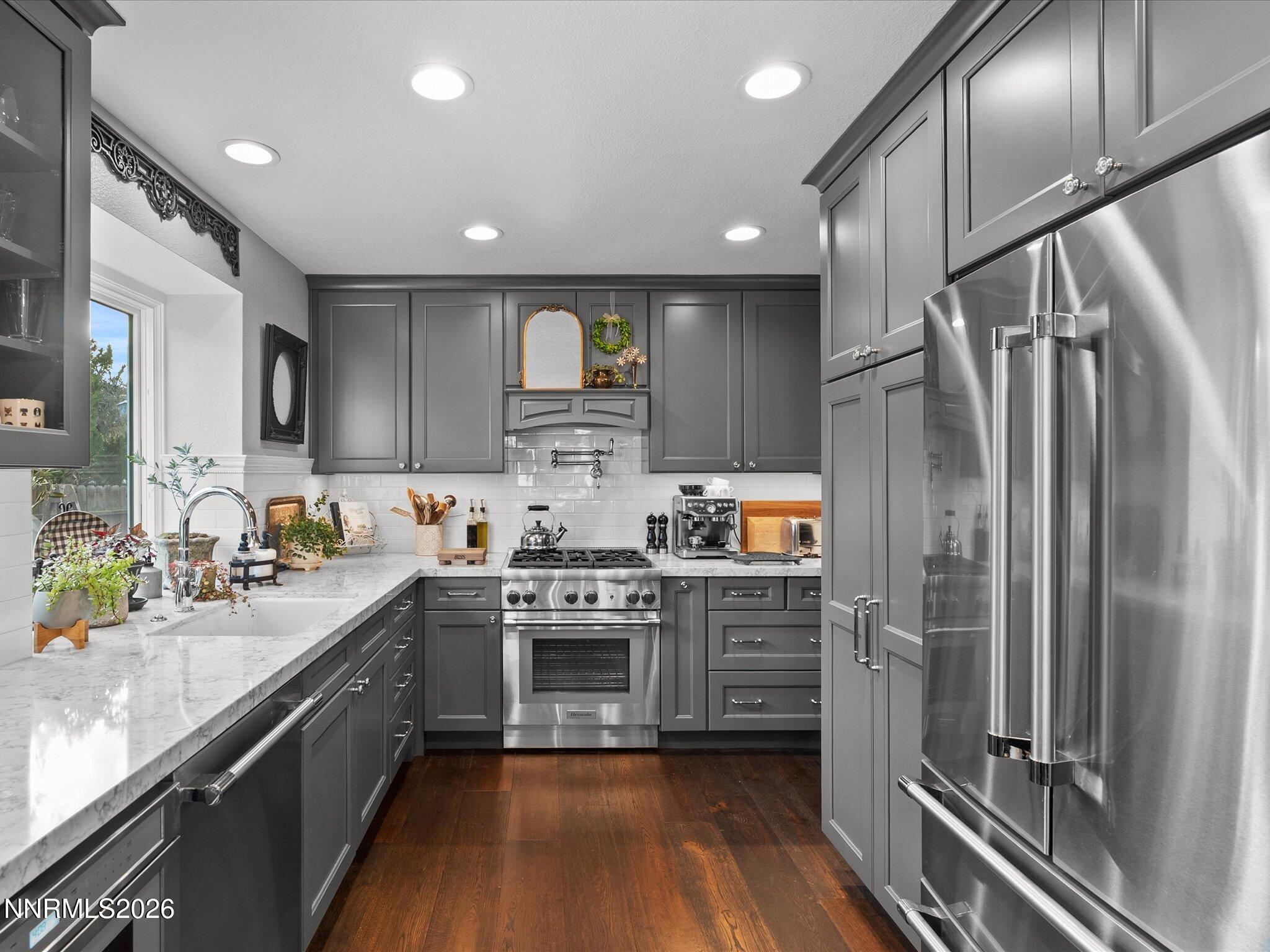 1164 Mayflower Drive Reno, NV 89509 - Photo 14 of 89 a kitchen with stainless steel appliances granite countertop a refrigerator a sink dishwasher a stove and white cabinets with wooden floor