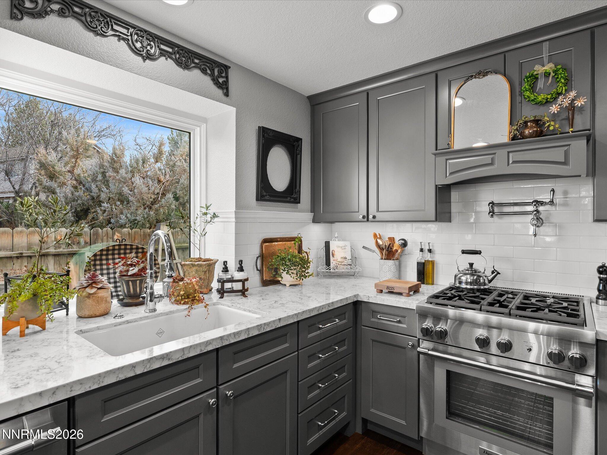 1164 Mayflower Drive Reno, NV 89509 - Photo 15 of 89 a kitchen with stainless steel appliances a stove a sink and a microwave