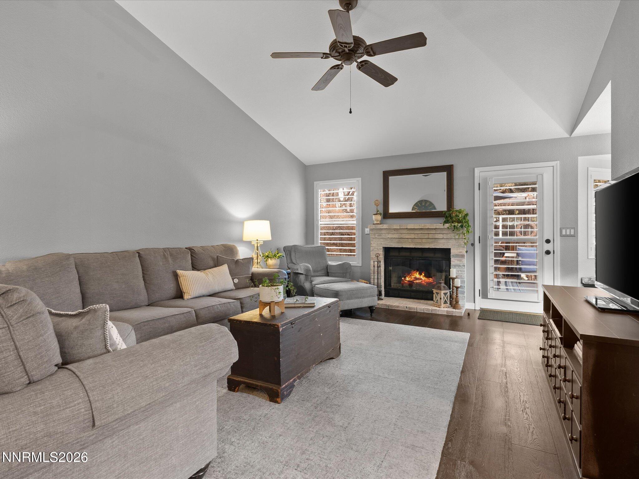1164 Mayflower Drive Reno, NV 89509 - Photo 24 of 89 a living room with furniture a fireplace and a flat screen tv