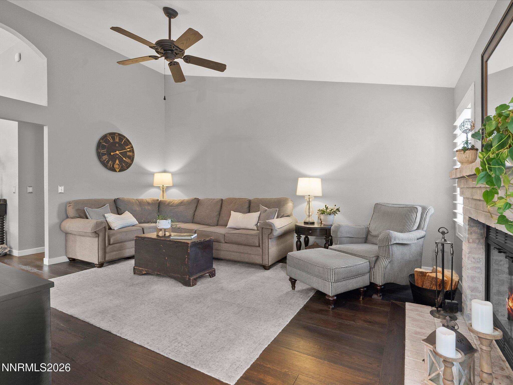 1164 Mayflower Drive Reno, NV 89509 - Photo 25 of 89 a living room with couches a coffee table and a clock on the wall