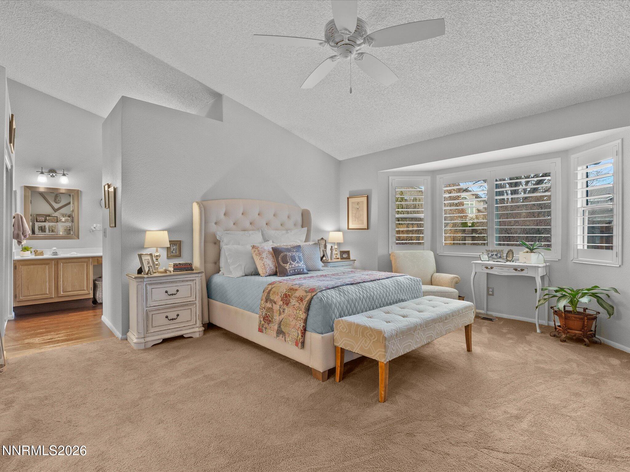 1164 Mayflower Drive Reno, NV 89509 - Photo 29 of 89 a spacious bedroom with a large bed and a chandelier fan
