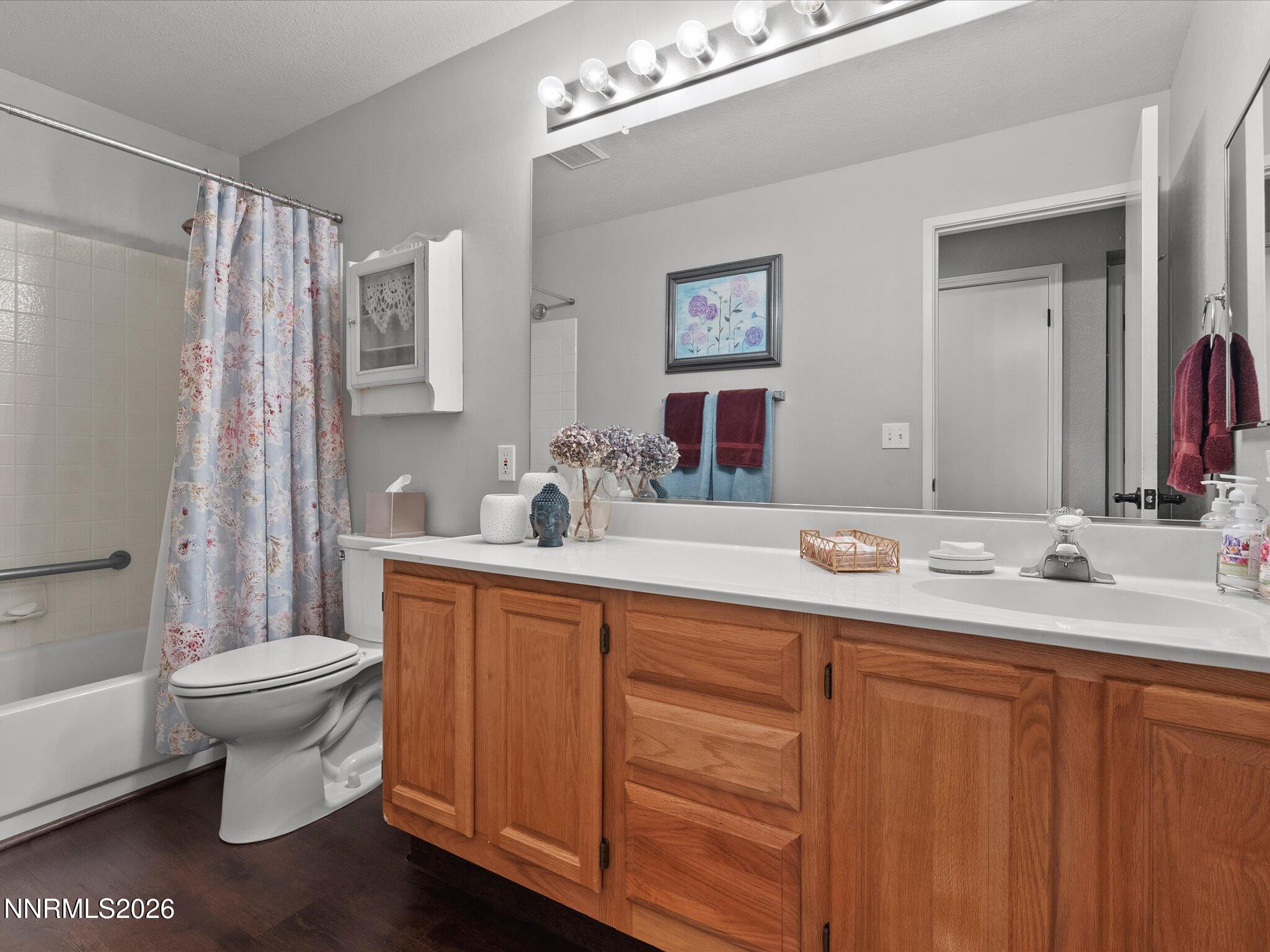 1164 Mayflower Drive Reno, NV 89509 - Photo 39 of 89 a bathroom with a toilet sink and mirror