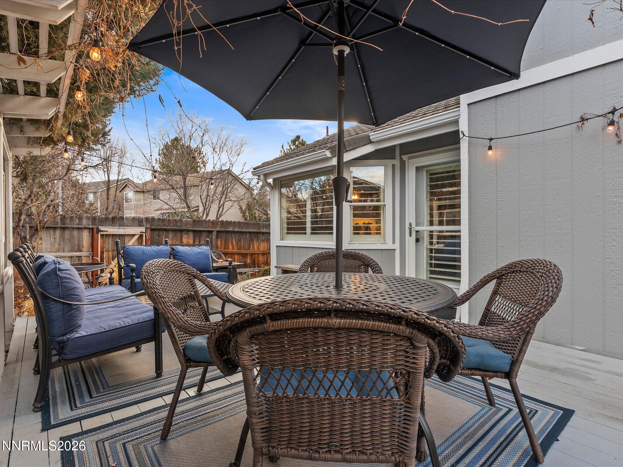 1164 Mayflower Drive Reno, NV 89509 - Photo 42 of 89 a view of a patio with a table and chairs under an umbrella