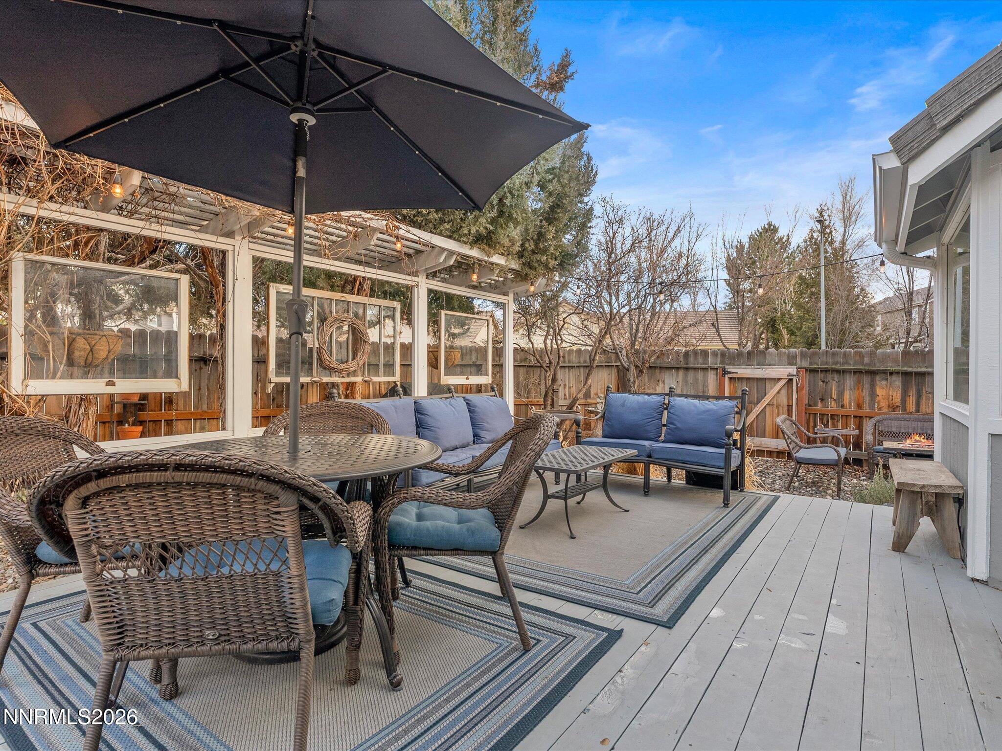 1164 Mayflower Drive Reno, NV 89509 - Photo 43 of 89 a view of a roof deck with table and chairs under an umbrella