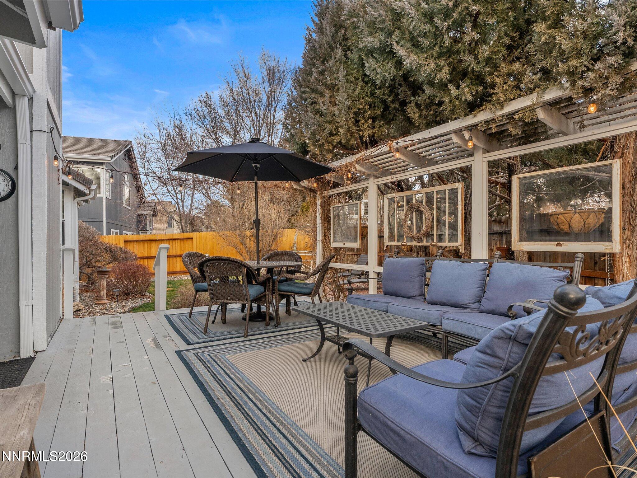 1164 Mayflower Drive Reno, NV 89509 - Photo 44 of 89 a view of a patio with table and chairs under an umbrella with a barbeque