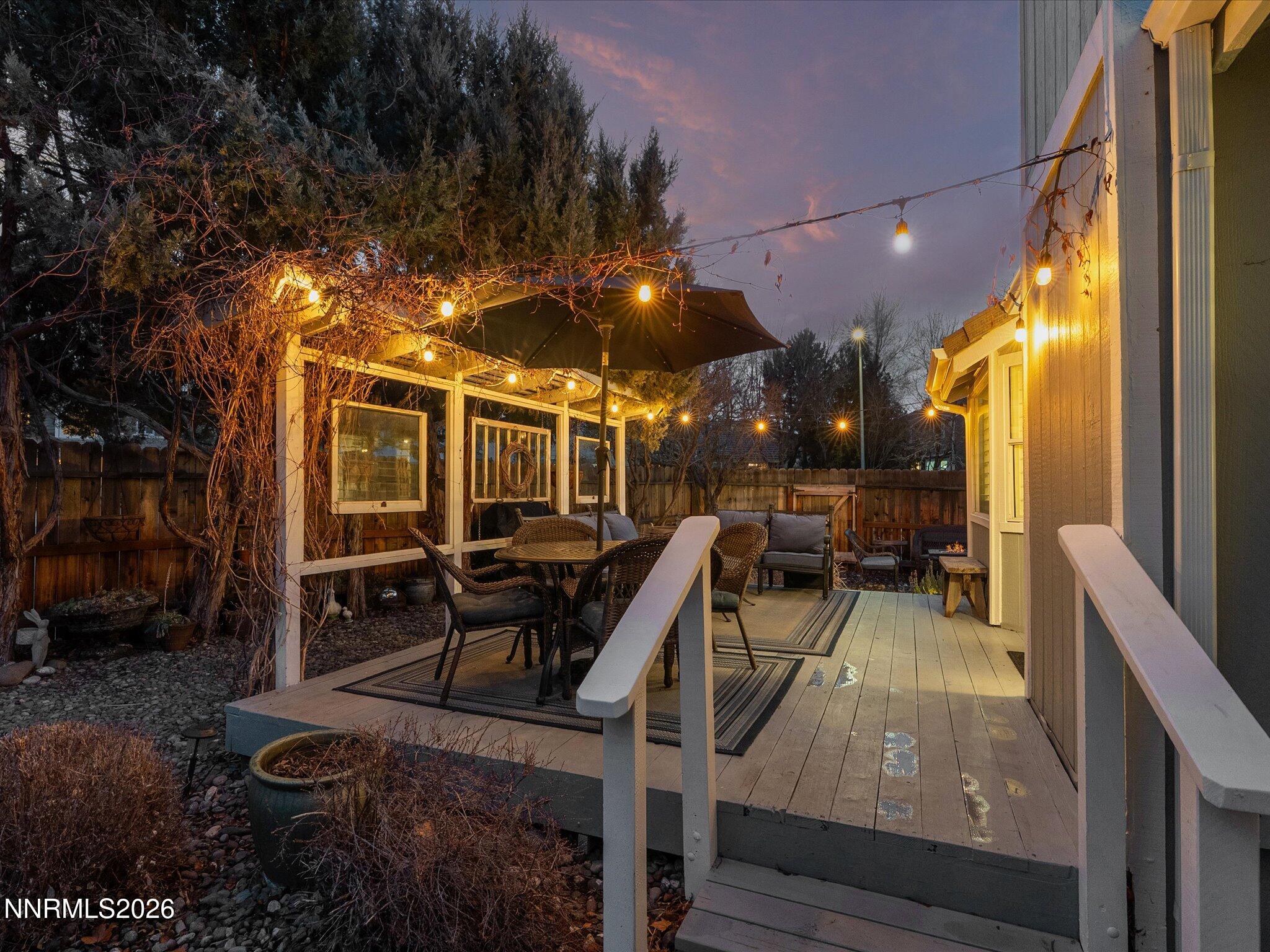 1164 Mayflower Drive Reno, NV 89509 - Photo 8 of 89 a view of a patio with table and chairs with wooden floor and fence