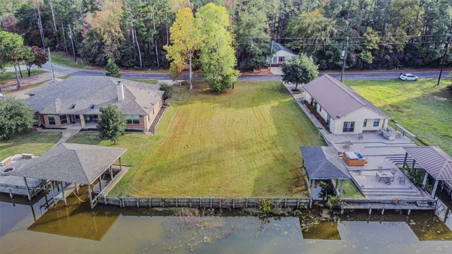 an aerial view of a house with swimming pool and outdoor seating