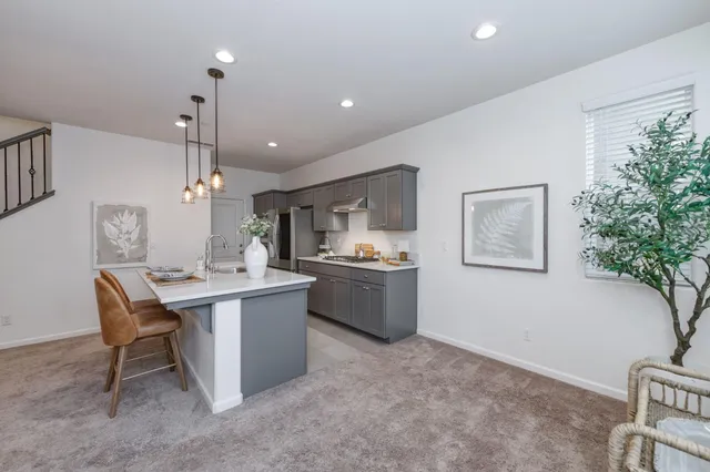 a kitchen with a table and chairs in it