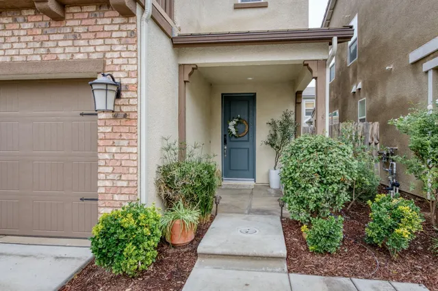 a view of a house with potted plants