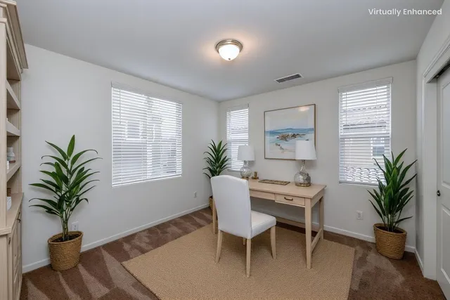 a dining room with furniture potted plants and wooden floor
