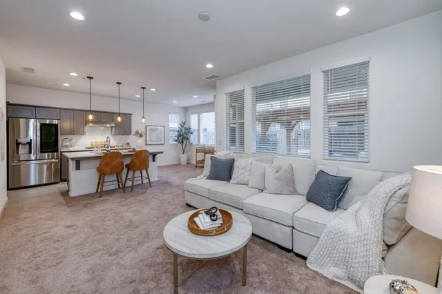 a living room with furniture and kitchen view